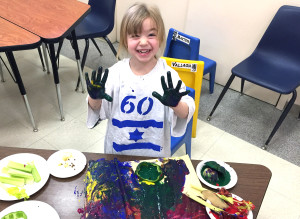 Preschooler enjoys multicolored fun during a Tot Shabbat Service